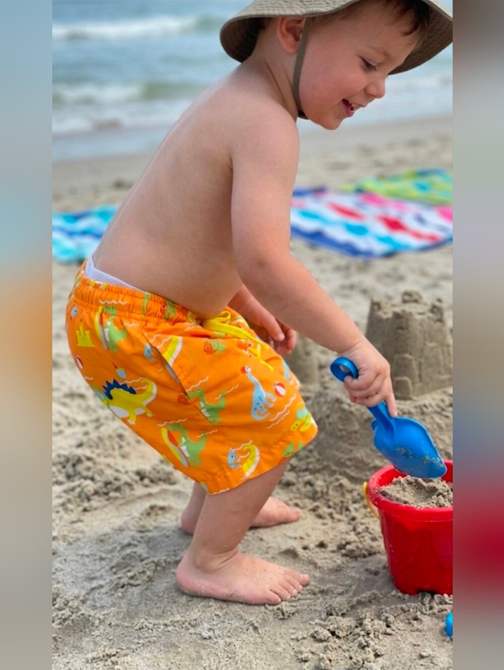 ​Title: KINNLY 3T Boys Orange Dinosaur Swim Trunks - EUC